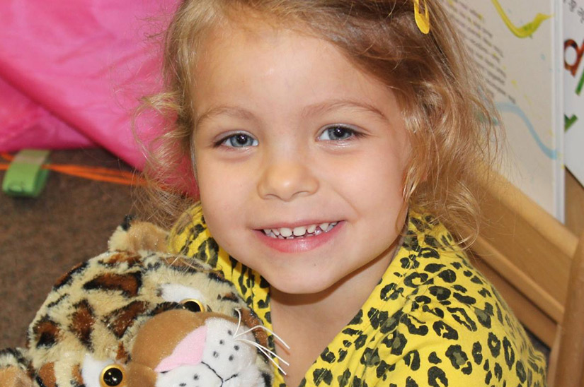 Girl with stuffed animal - Webster Child Care Center
